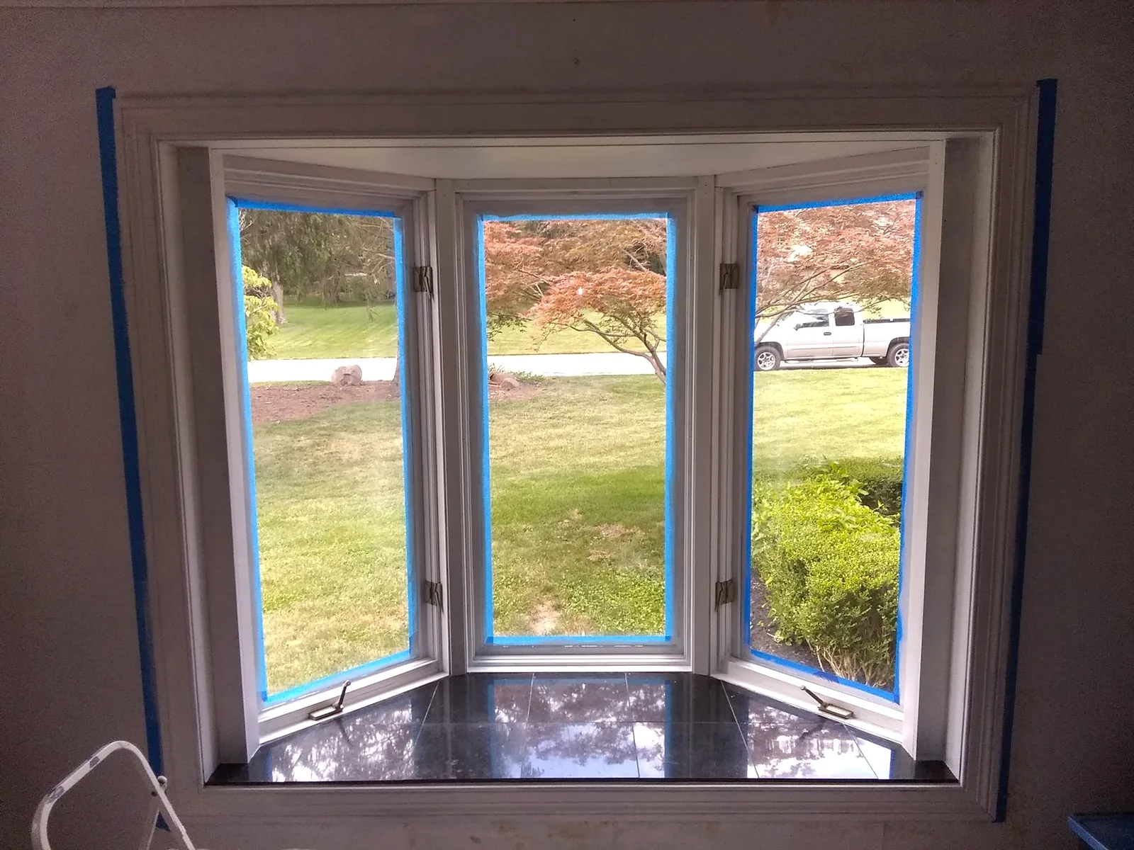 Bay window during finish work with blue masking tape